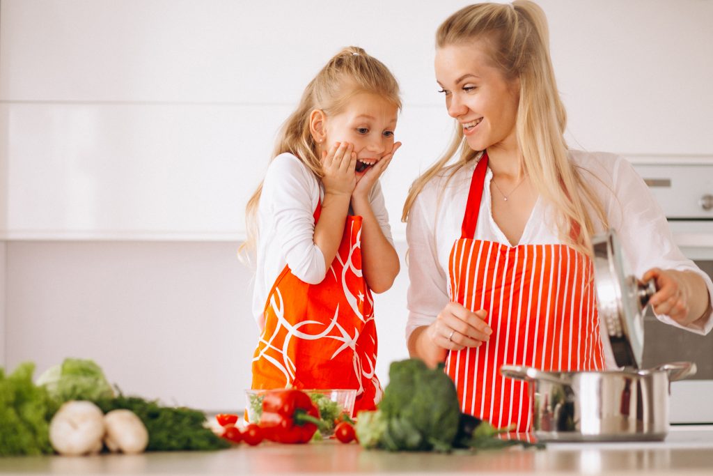 mom and daughter cooking