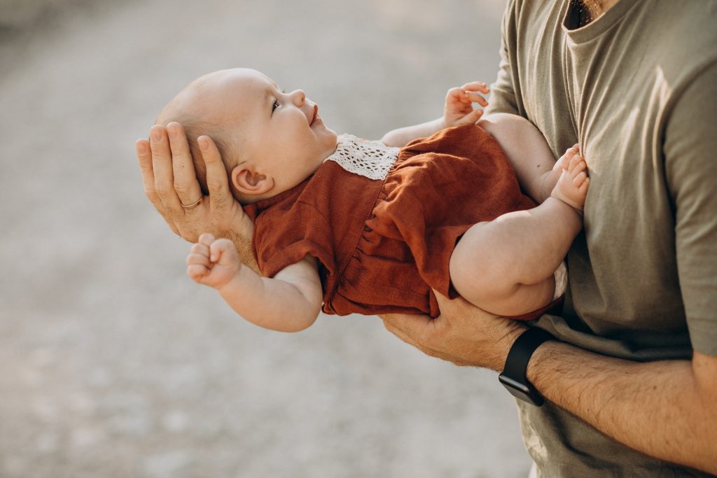 Father with his baby girl in hands