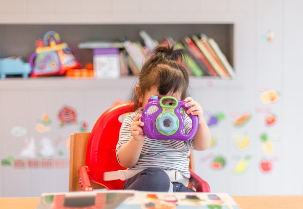 baby with camera, develop toddler confidence