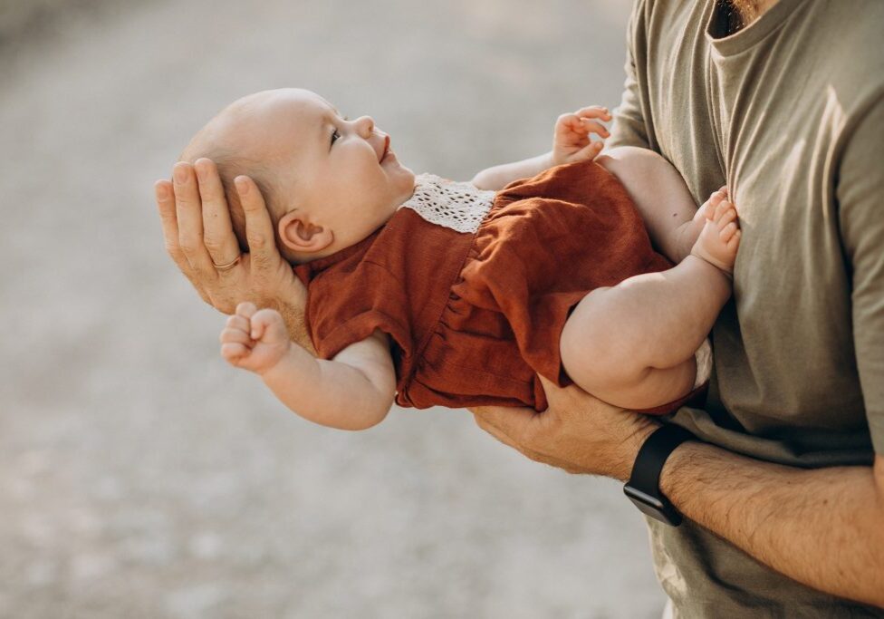 Father with his baby girl in hands